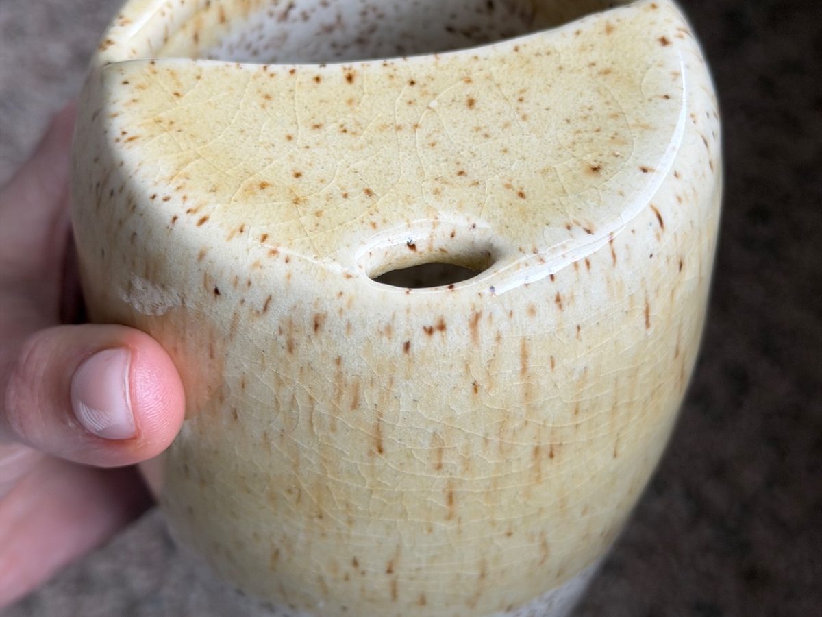 A minimal ceramic mug in soft light